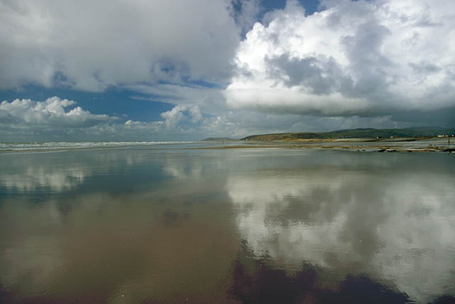 reflections in the wet sand at Borth