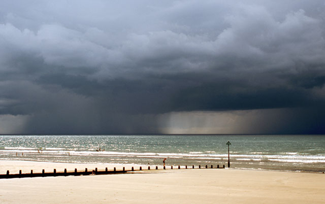 Sunny borth beach with thunderstorm beyond