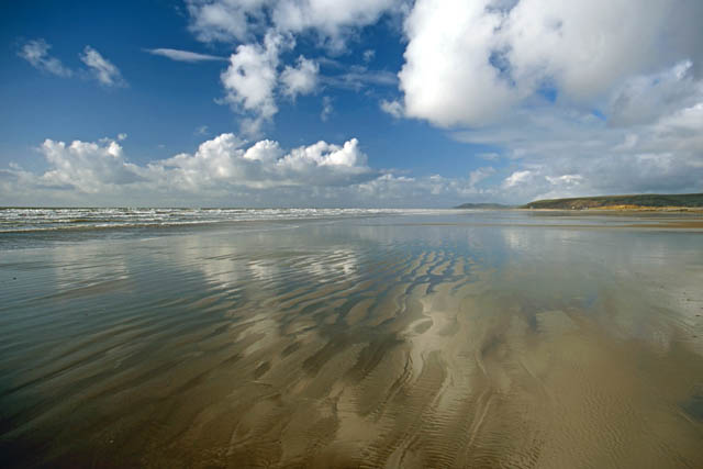 clouds reflected in wet sand at Borth